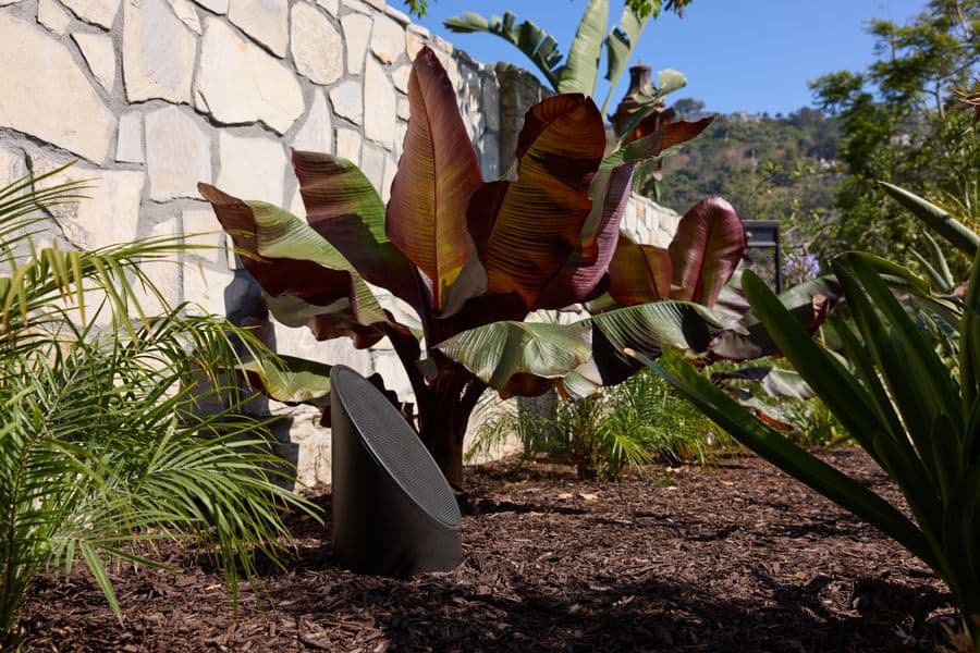 Coastal Source bollard speaker in a planting bed