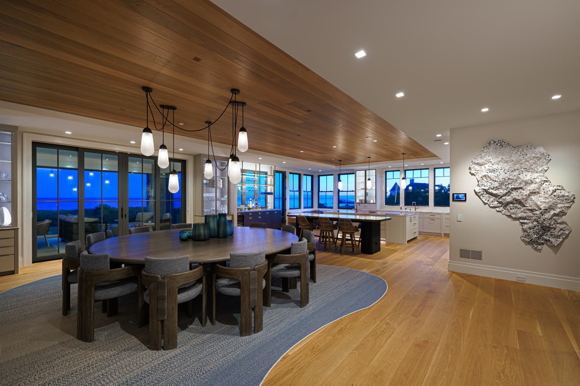Dining room with tunable lighting and ocean views at blue hour